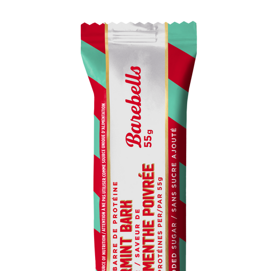 Barebells Peppermint Bark protein bar wrapped in red and mint green striped packaging with white center panel