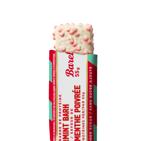 Barebells Peppermint Bark protein bar with white chocolate coating studded with pink peppermint pieces