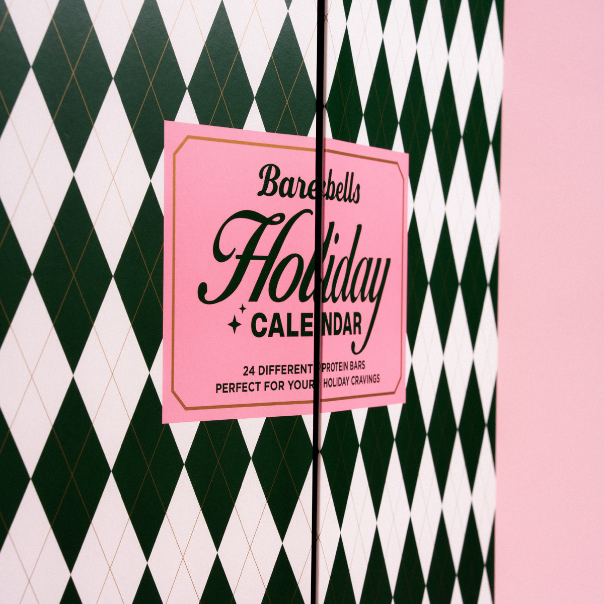 Barebells Holiday Calendar advent box with pink label on green and white diamond patterned packaging