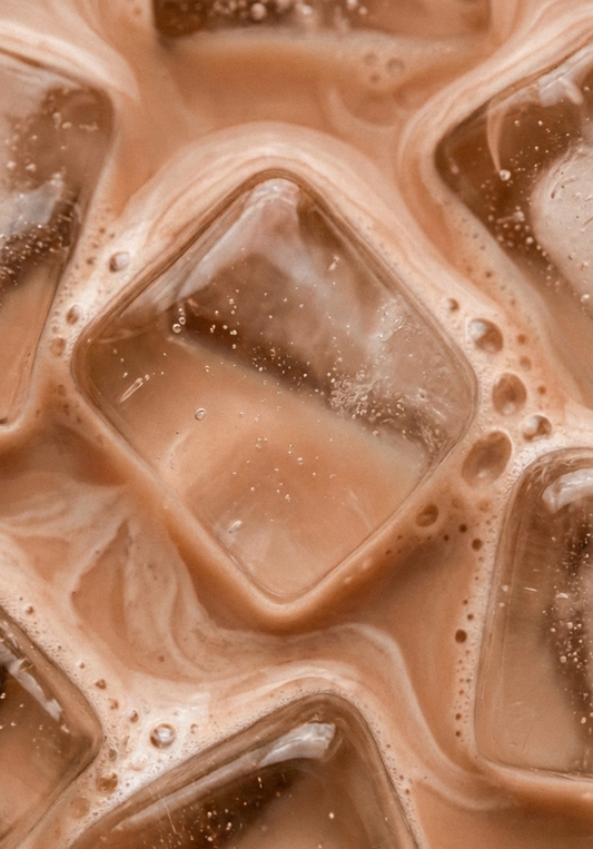 Close-up of chocolate milk drink texture with bubbles and creamy swirls